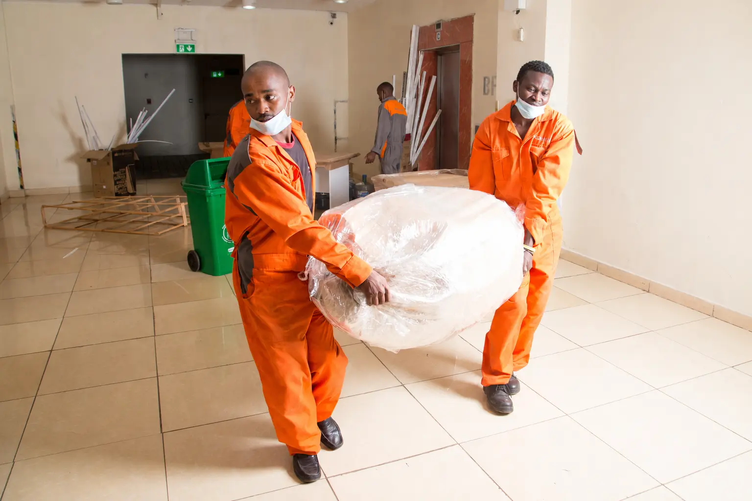 KejaMove movers carrying protected household furniture during a home relocation in Nairobi