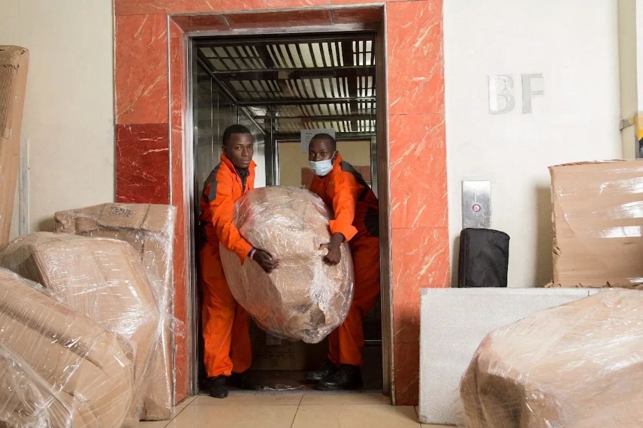 KejaMove movers carefully wrapping and moving items into secure storage in Nairobi